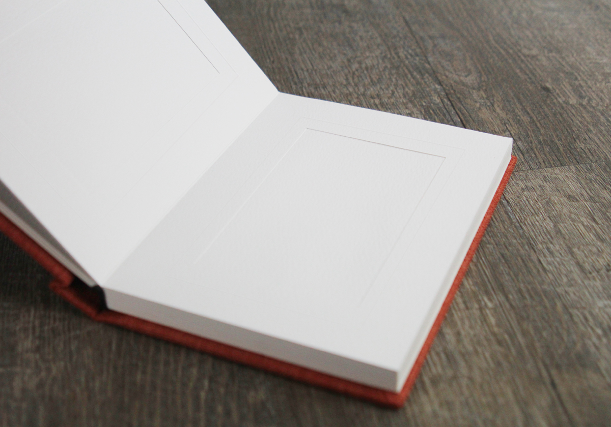 Reveal albums feature easy to slip-in matted pages